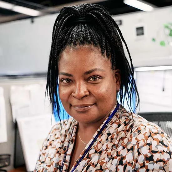 A photo of an office employee at her desk.
